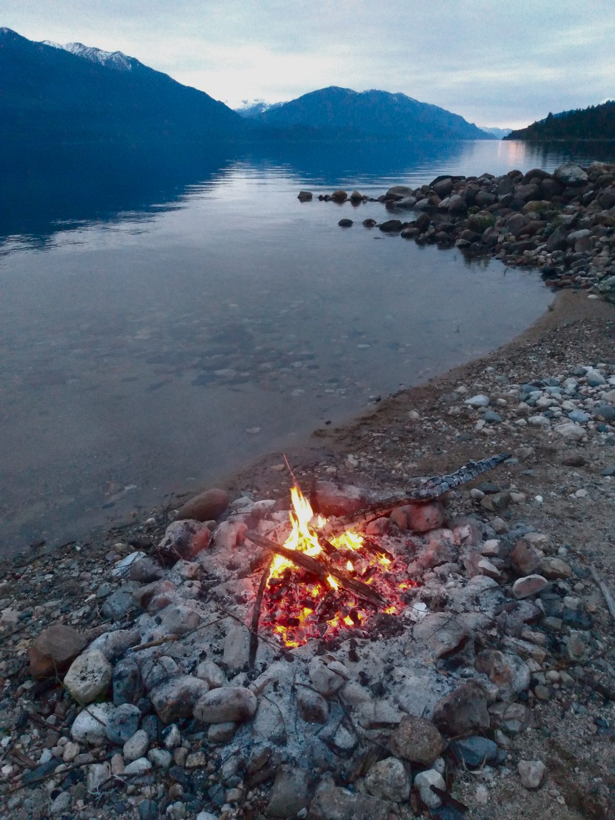 Only a few coals left in a fire next to Kootenay lake 